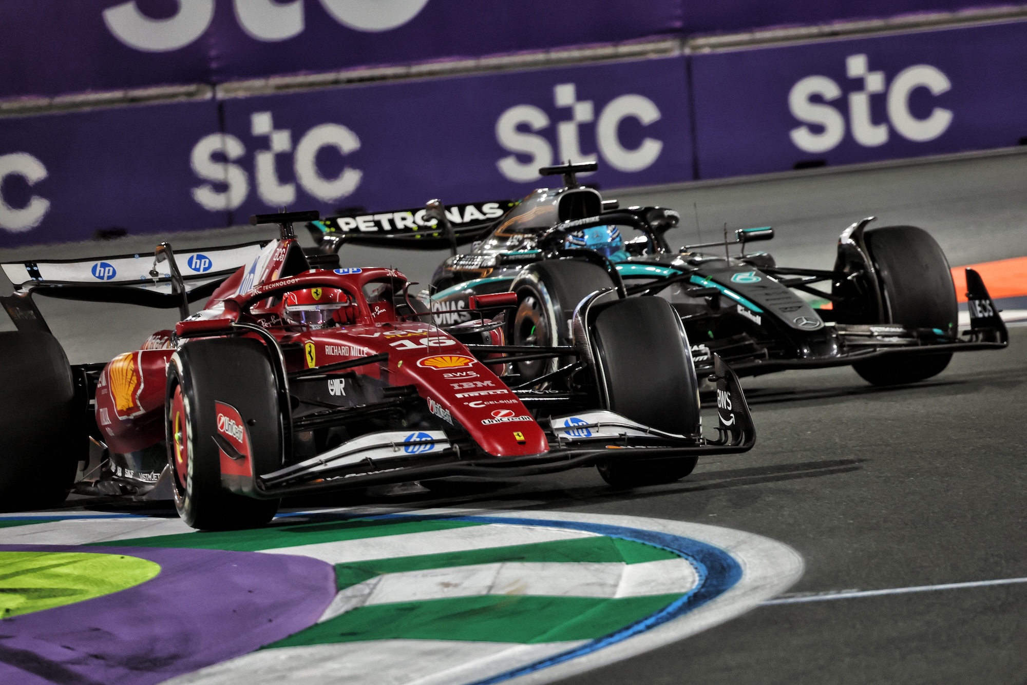 Charles Leclerc (MON) Ferrari SF-25 and George Russell (GBR) Mercedes AMG F1 W16 battle for position.
